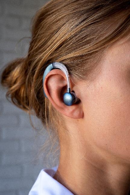 A person with a hearing aid.

AI-generated content may be incorrect.